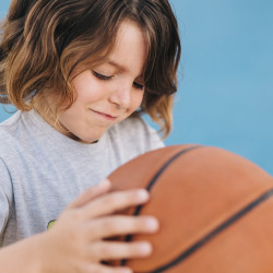medium-shot-kid-playing-basketball